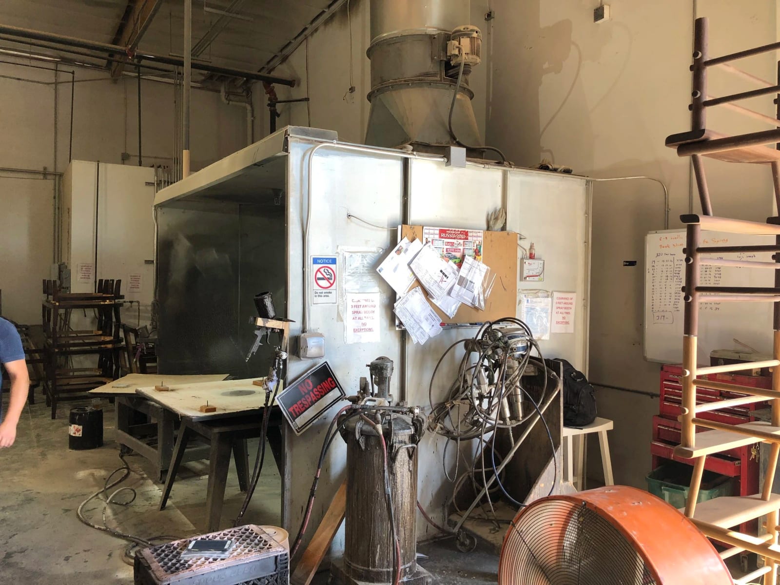 The spray booth in the finishing department, with frames waiting beside it