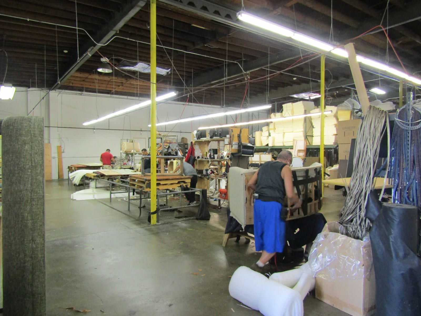 The upholstery floor, with pieces in progress and people at work